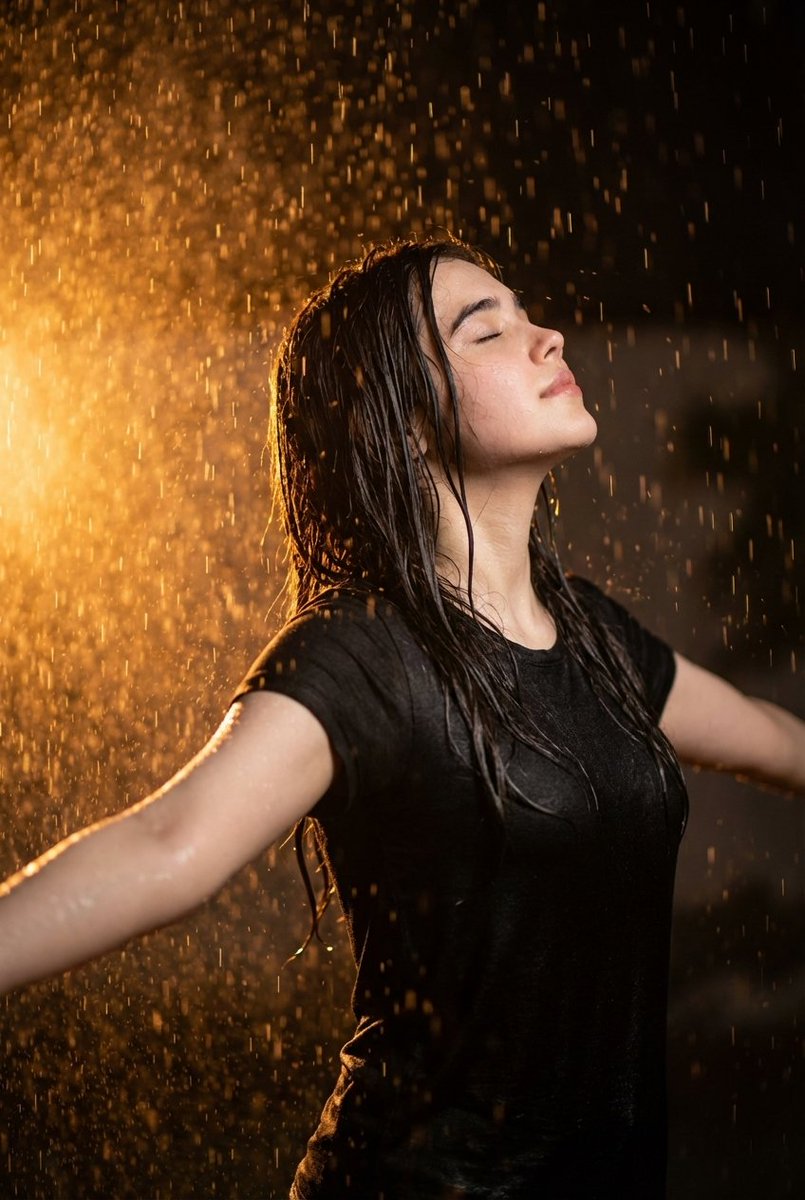Ultra realistic cinematic portrait of a 32-year-old young woman standing in heavy rain at night, ar…