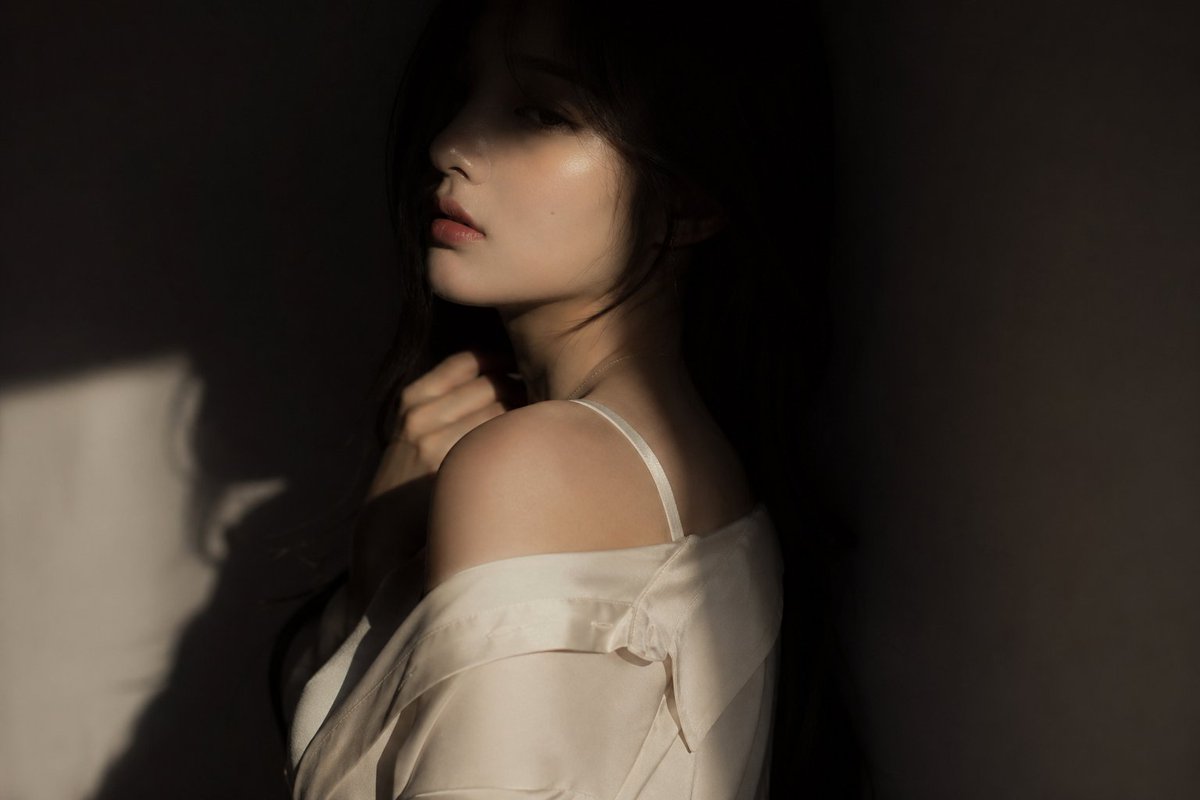 editorial portrait, Korean female idol, subtly sensual outfit: silk shirt or soft fabric top, sligh…